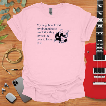 a pink t - shirt with a picture of a man playing a guitar