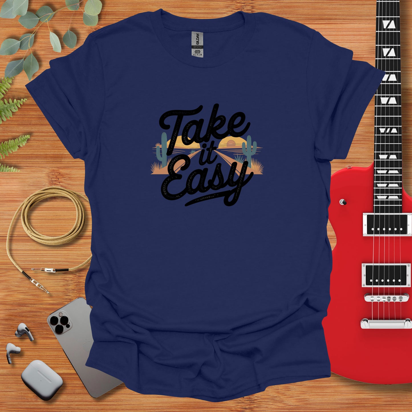 a t - shirt that says take easy with a guitar next to it