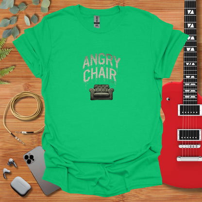 a green t - shirt with the words angry chair on it next to a guitar