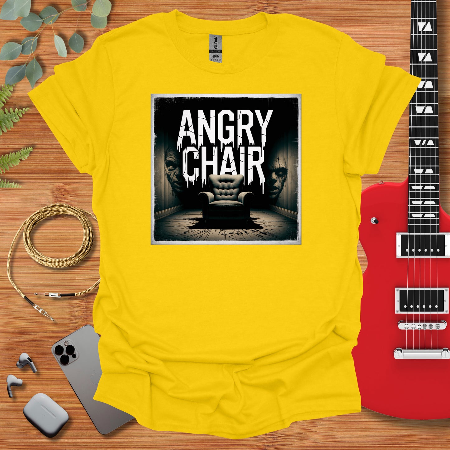 a yellow t - shirt with an image of an angry chair on it