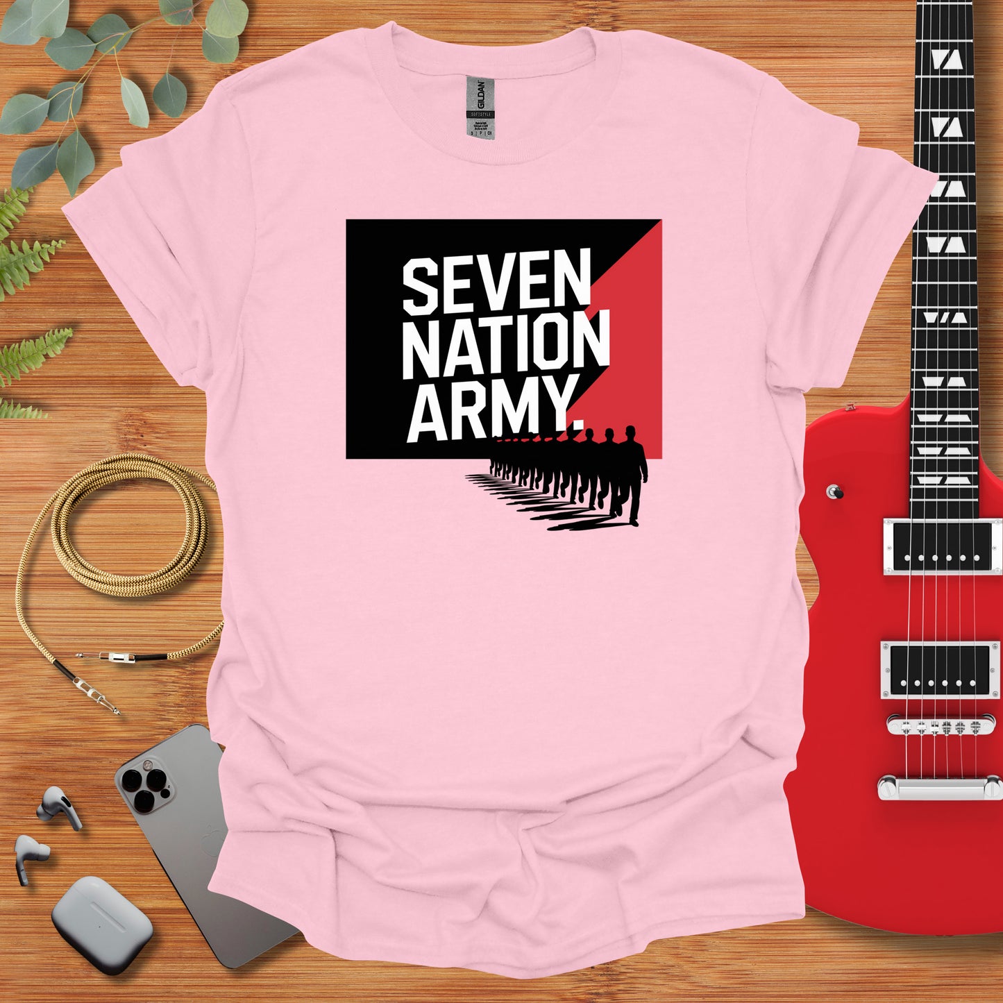 a pink t - shirt with the words seven nation army on it