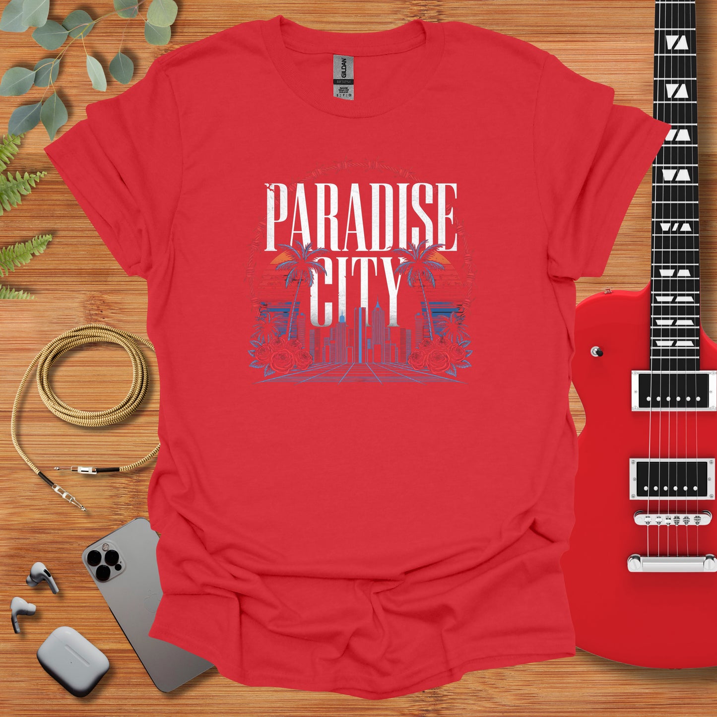 a red shirt with the words paradise city on it