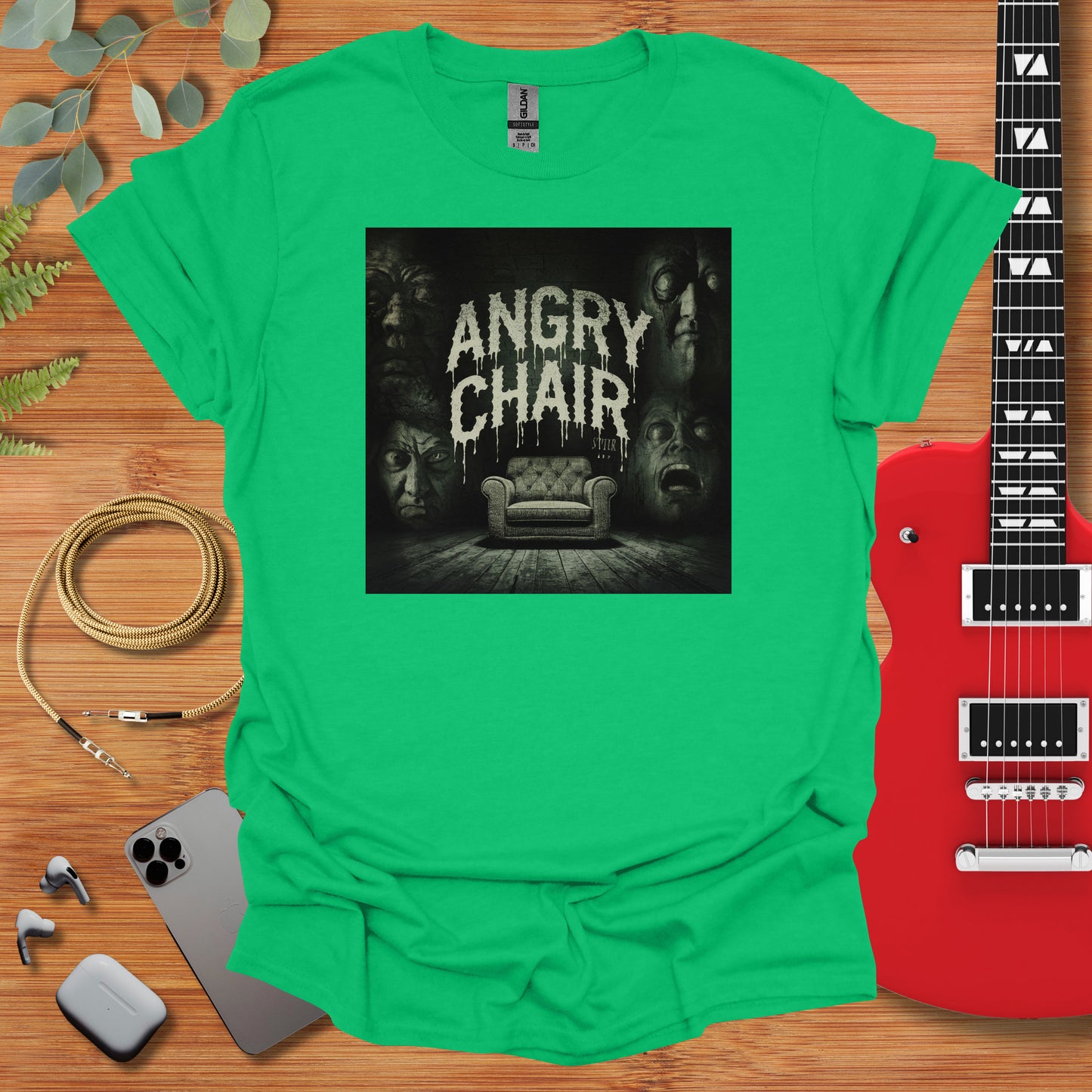 a green t - shirt with an image of a chair and a guitar