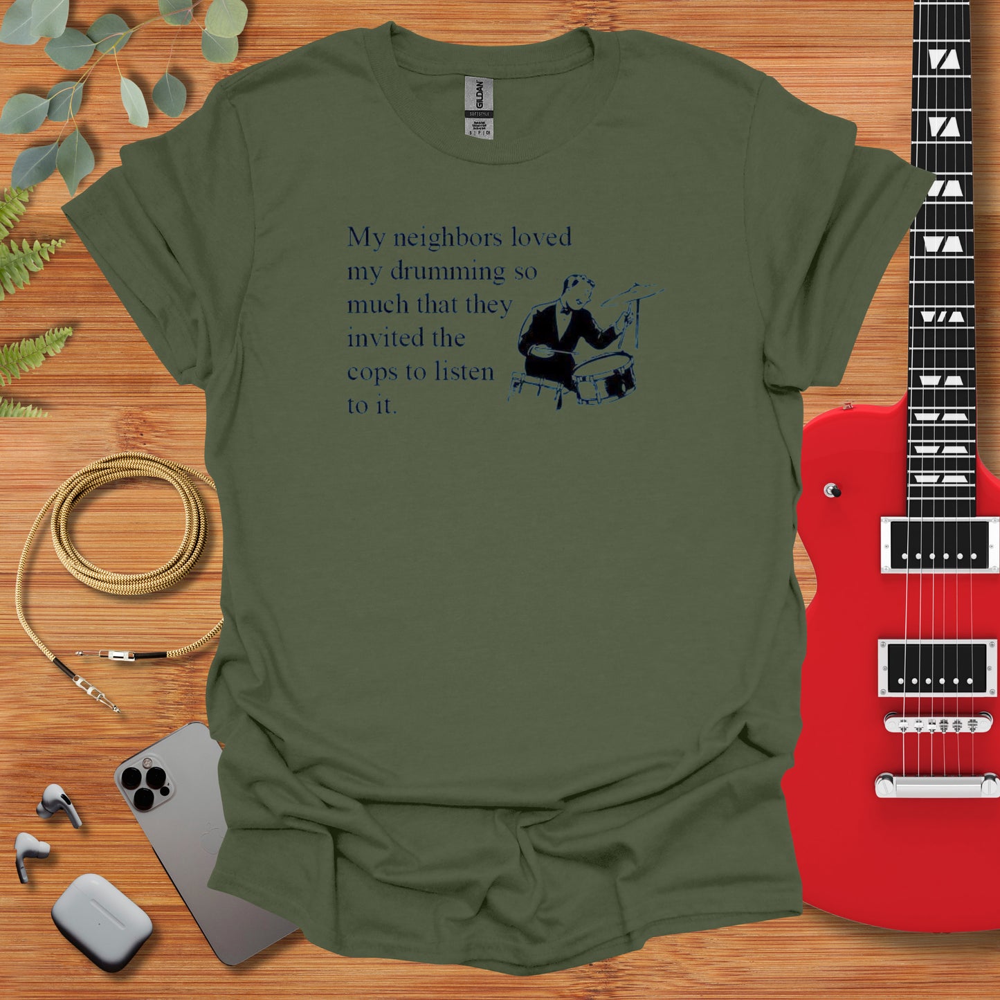 a green t - shirt with a guitar and a guitar