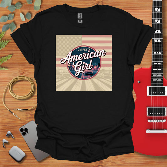 an american girl t - shirt with a guitar next to it