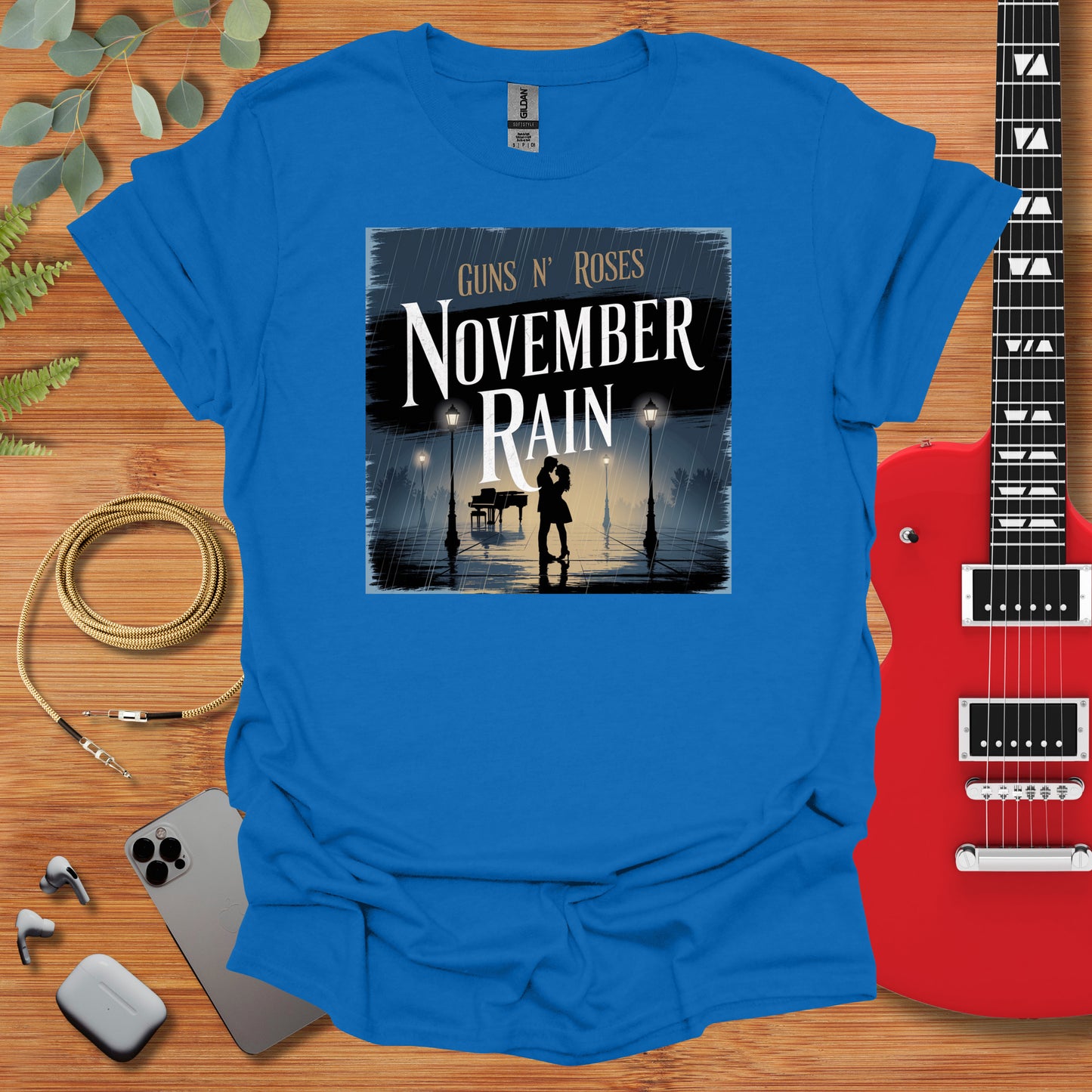 a blue shirt with a picture of a man holding a guitar