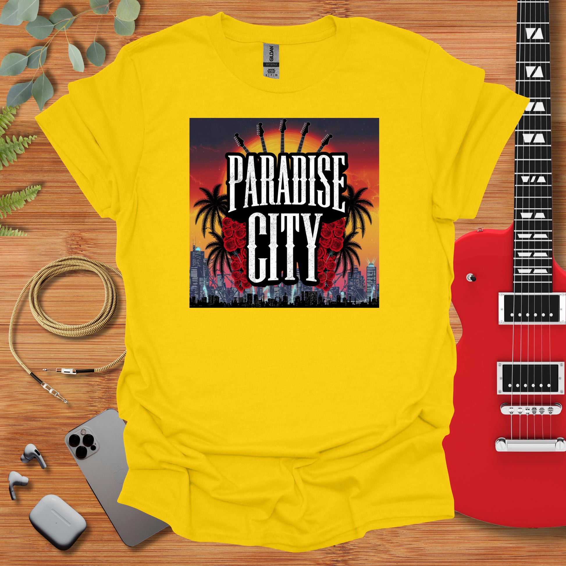 a yellow t - shirt with the words paradise city on it