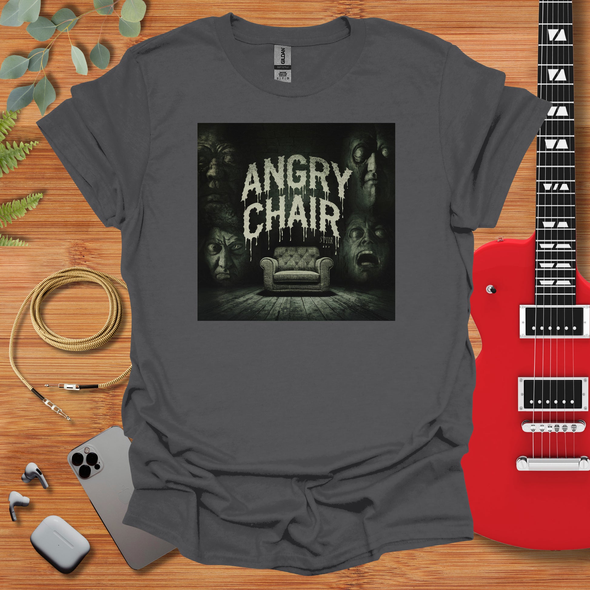 a t - shirt with an image of a couch and a guitar