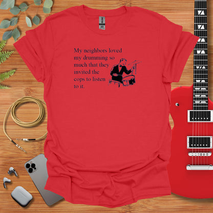 a red t - shirt with a guitar next to it