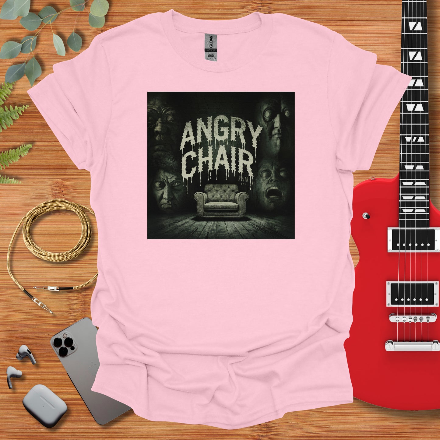 a t - shirt with an image of a couch and a guitar