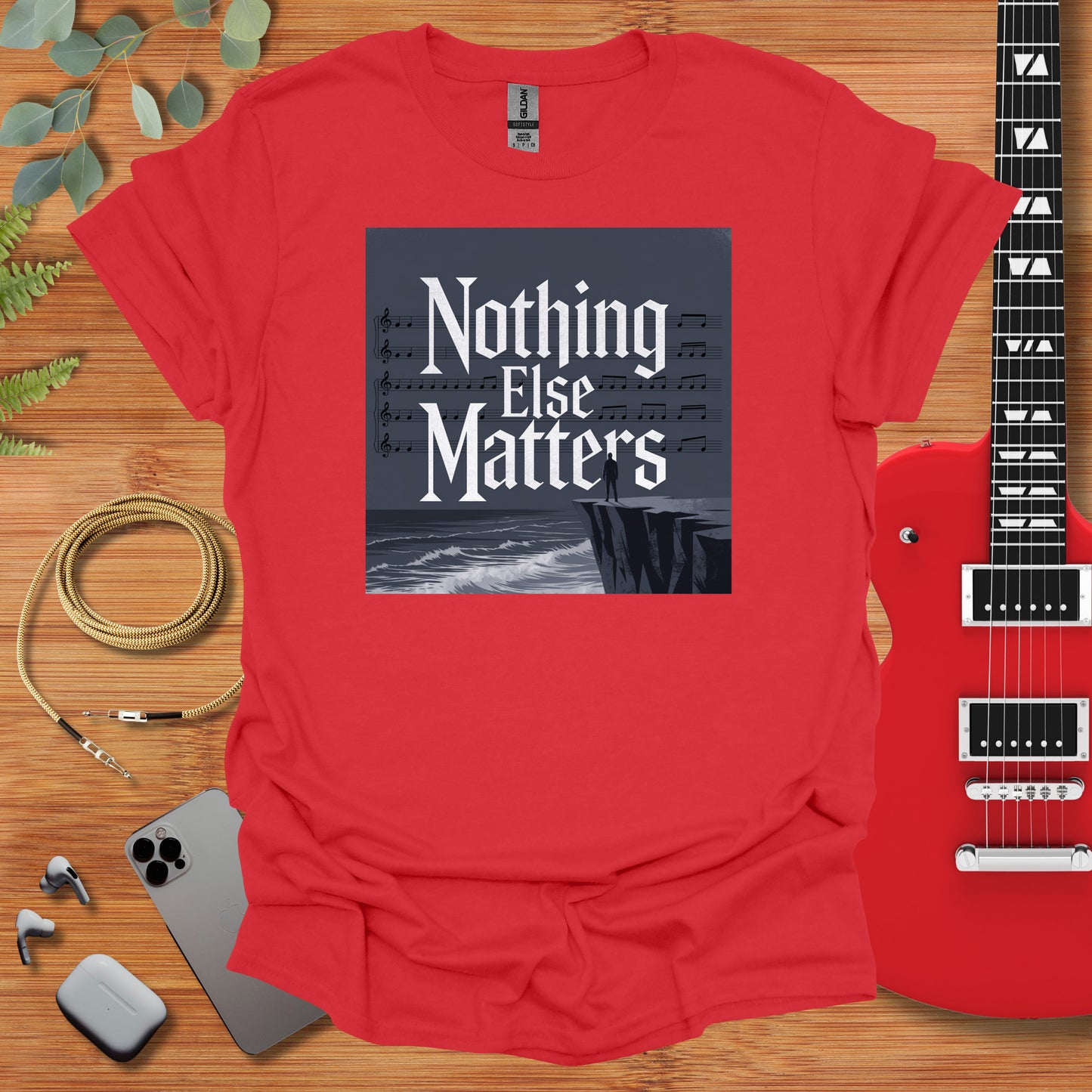 a t - shirt that says nothing else matters next to a guitar