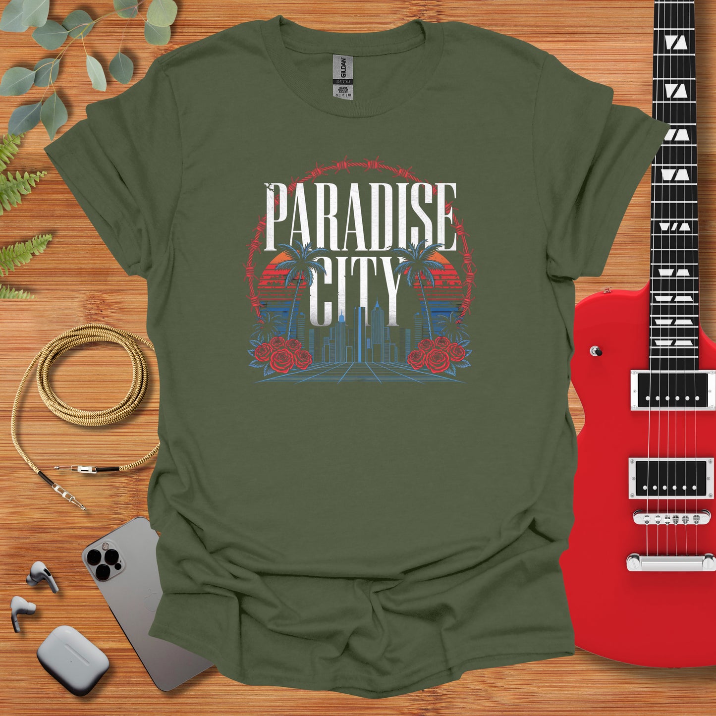 a t - shirt that says paradise city with a guitar next to it