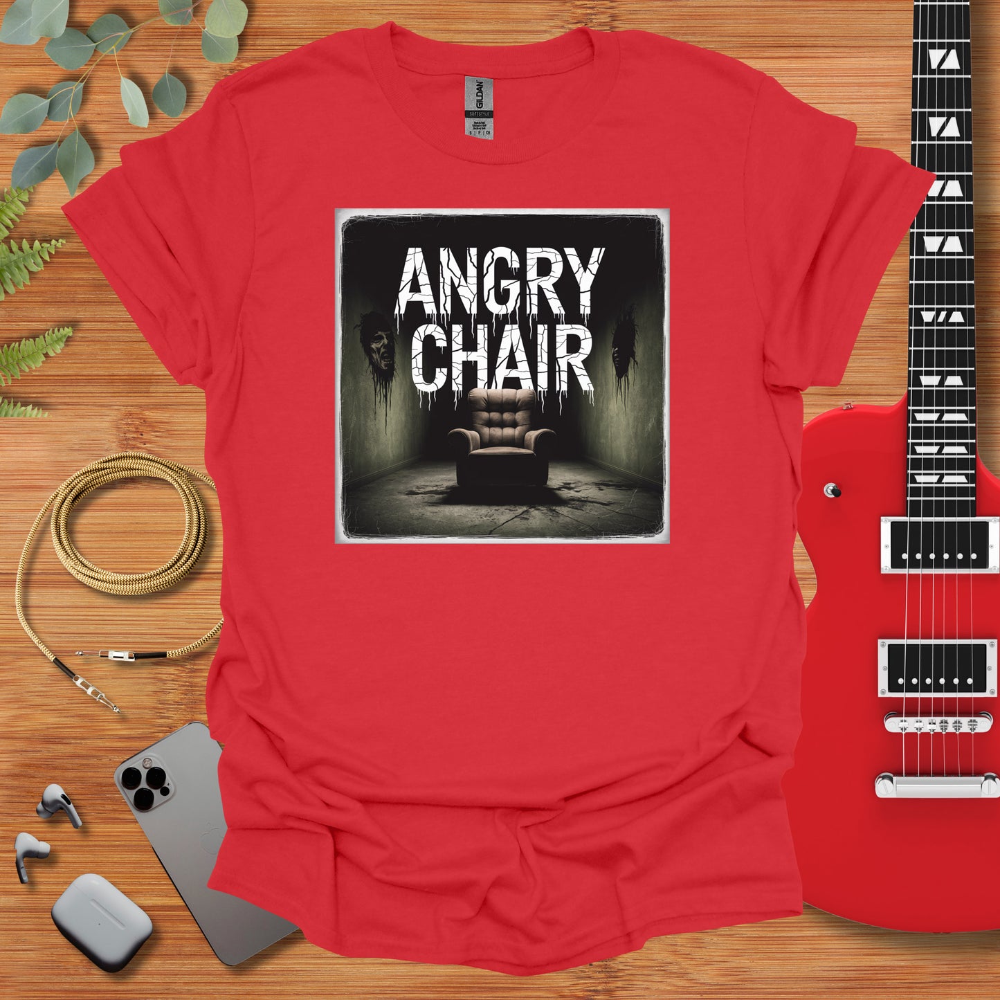 a red shirt with an image of a chair and a guitar