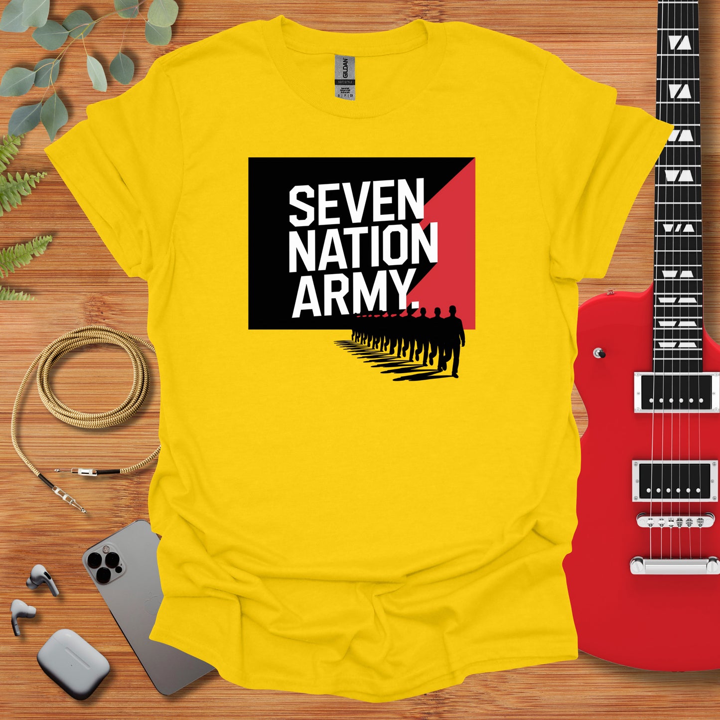 a yellow t - shirt with the words seven nation army on it