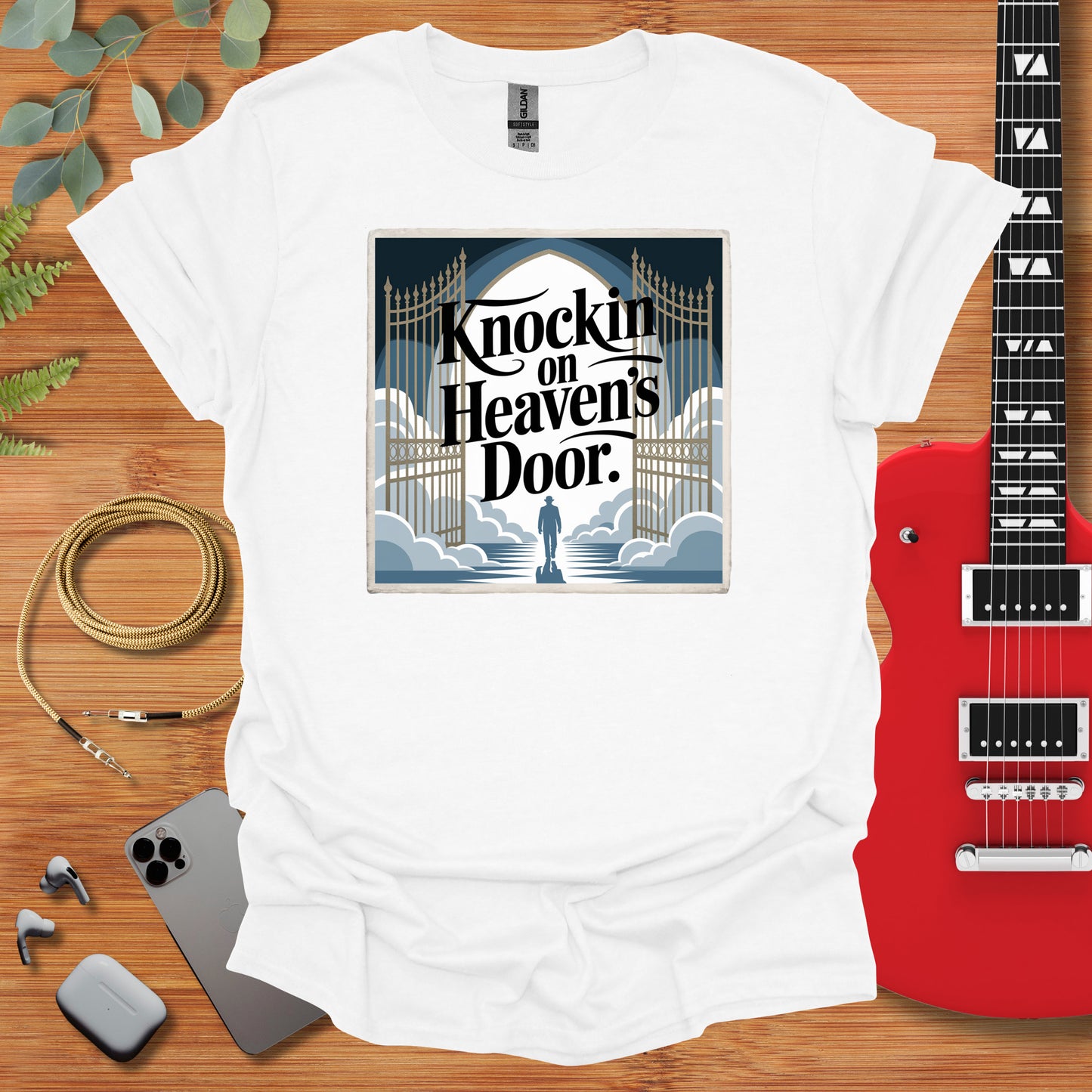 a t - shirt with a guitar and a guitar case next to it