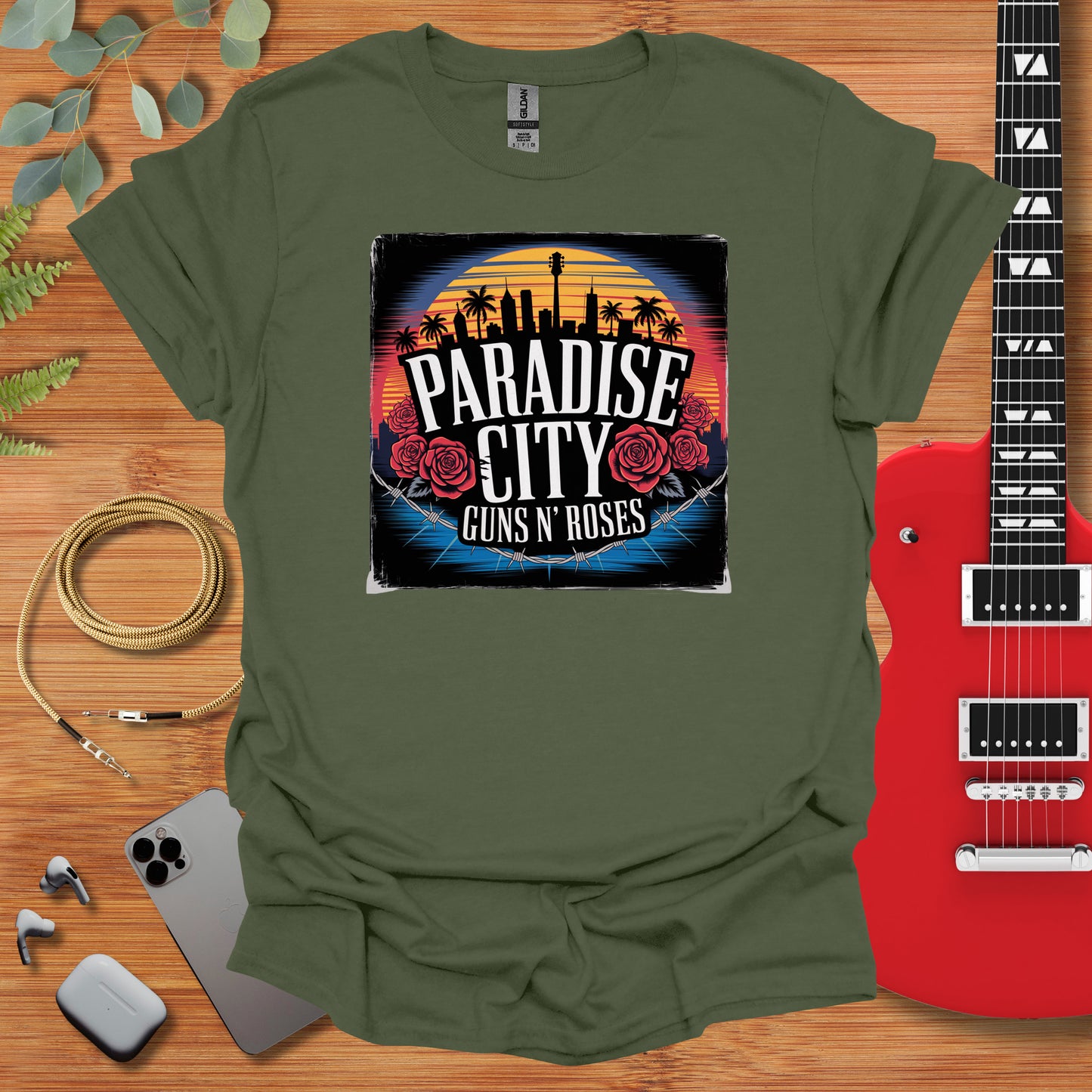 a green t - shirt with the phrase paradise city guns and roses on it