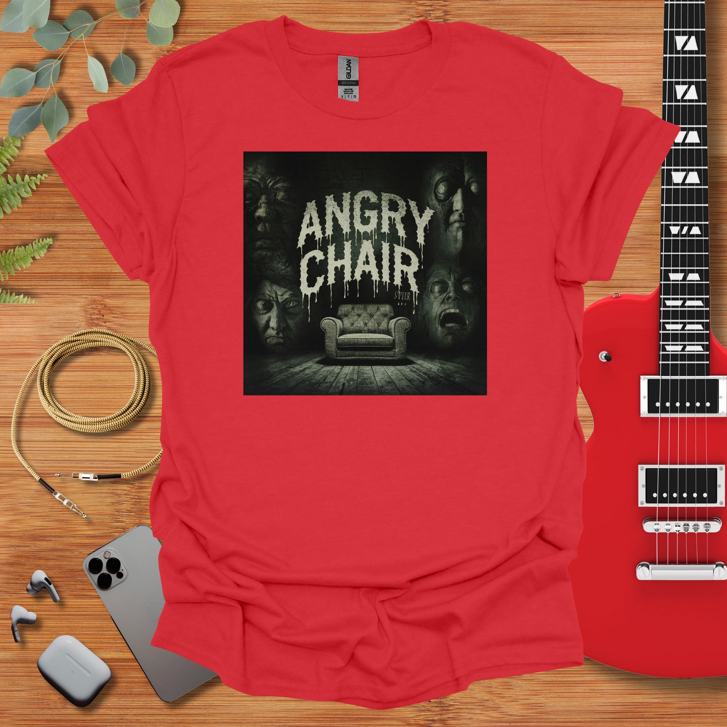 a red shirt with an image of a couch and a guitar