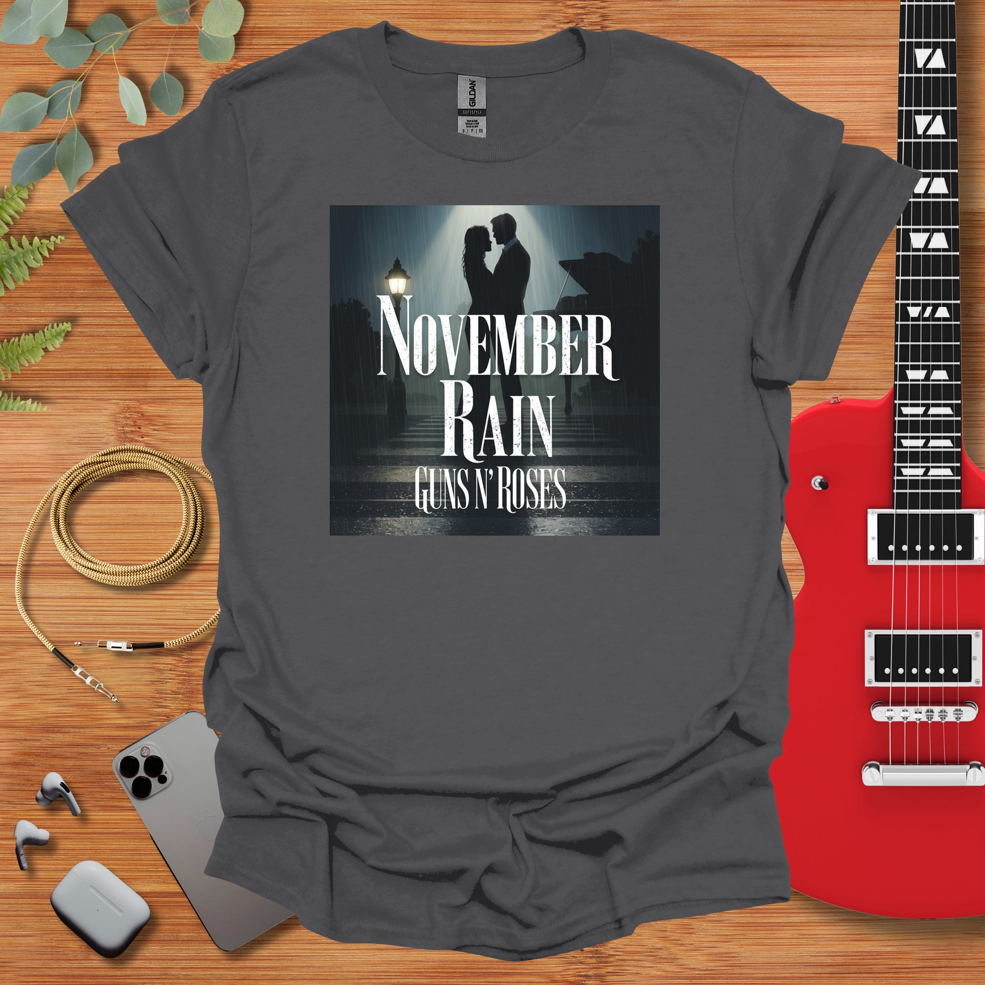 a t - shirt with the words november rain and a guitar next to it