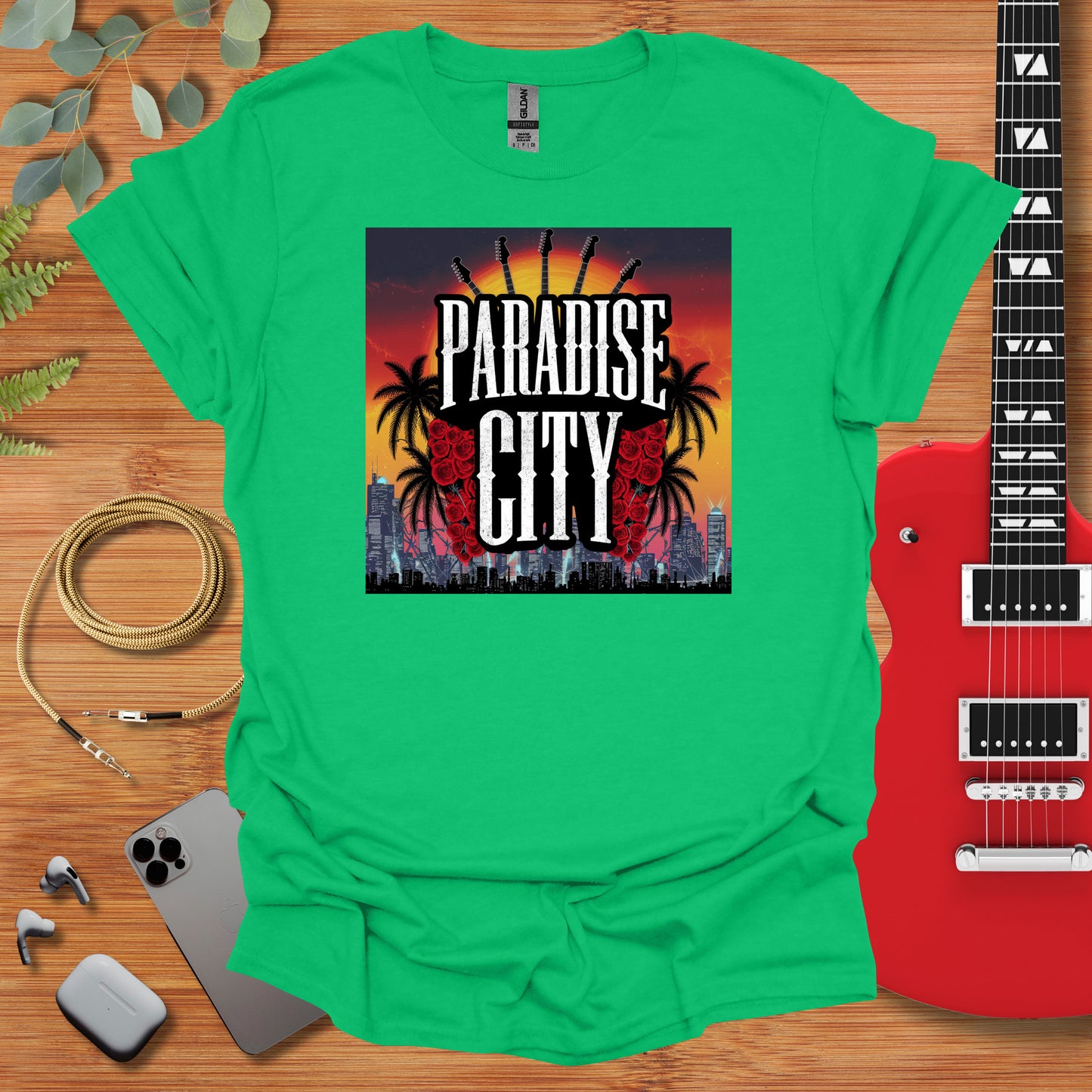 a green shirt with the words paradise city on it