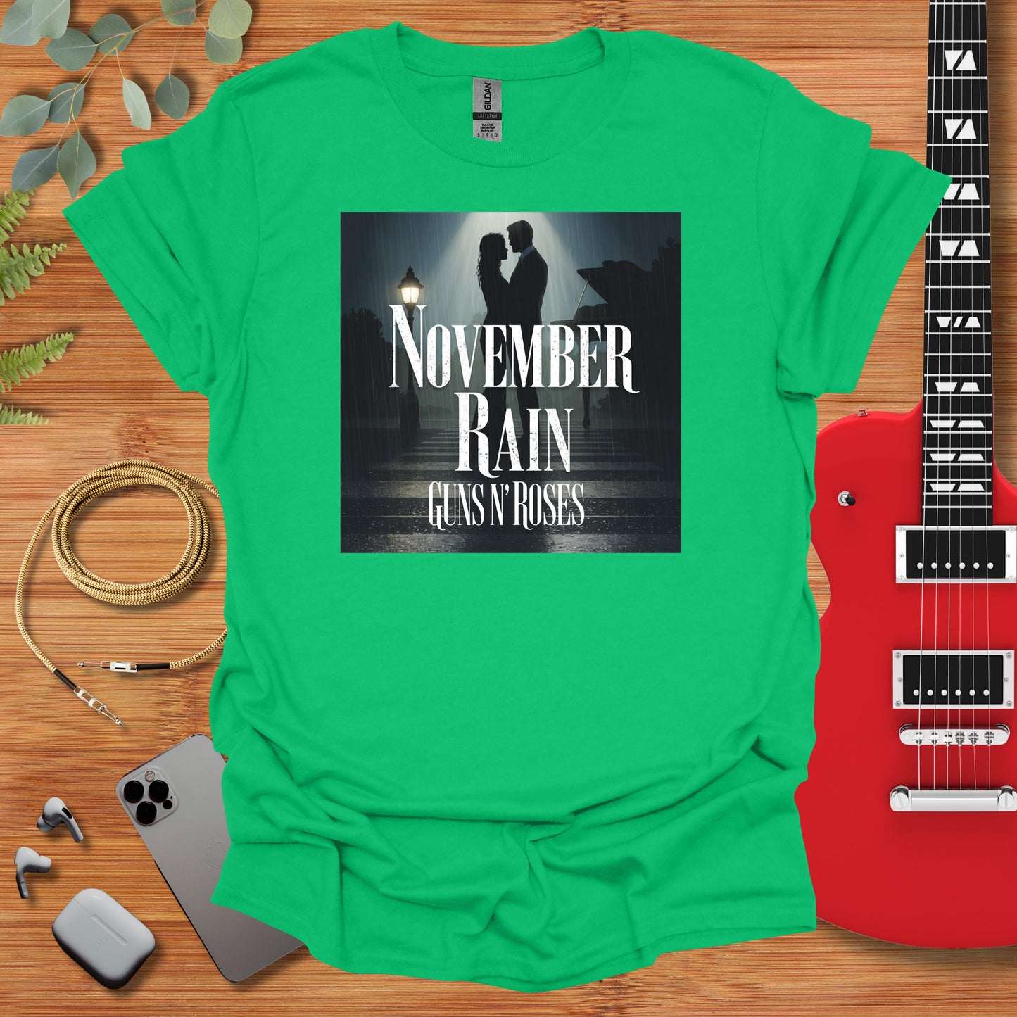 a green t - shirt with the words november rain and a guitar