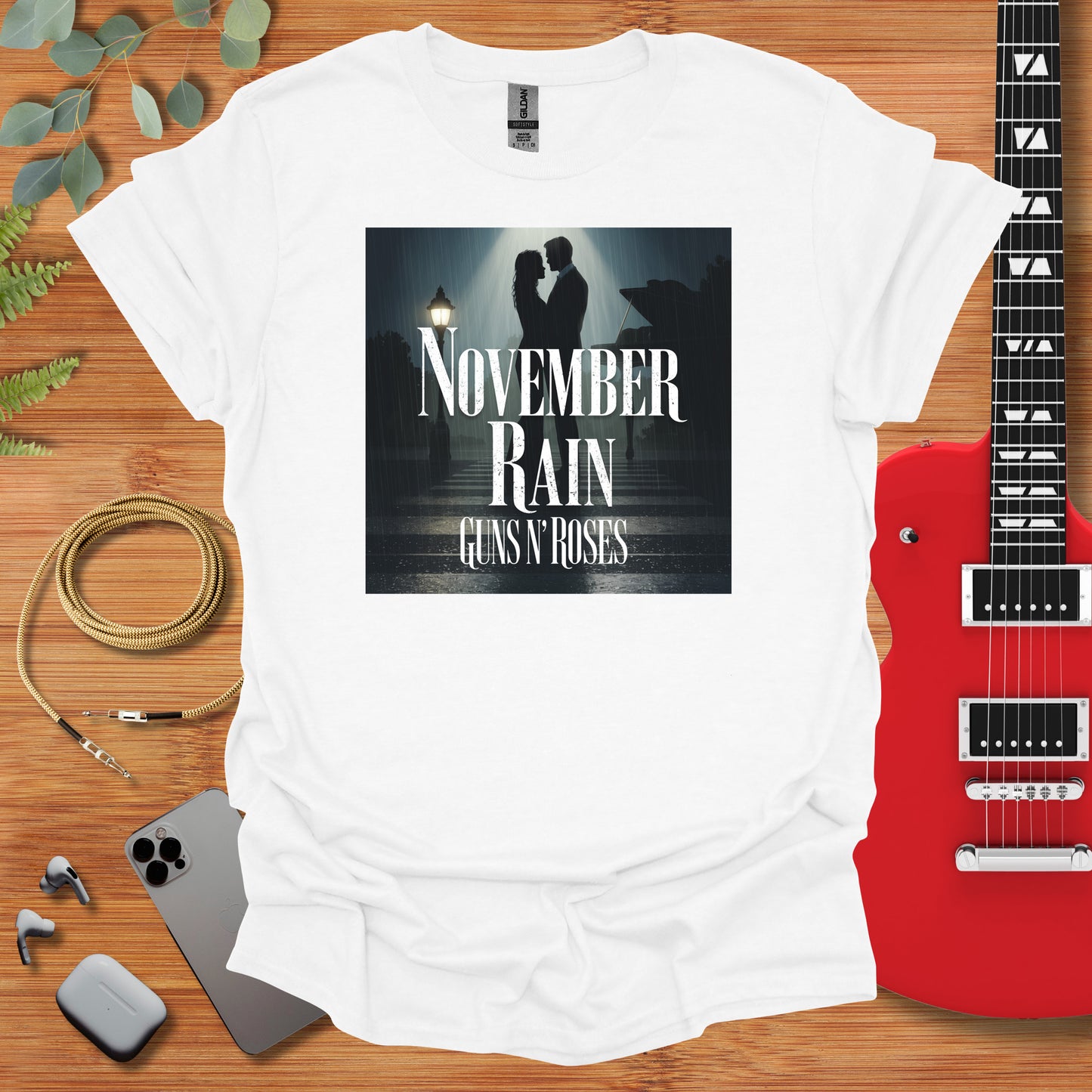 a t - shirt that reads november rain next to a guitar