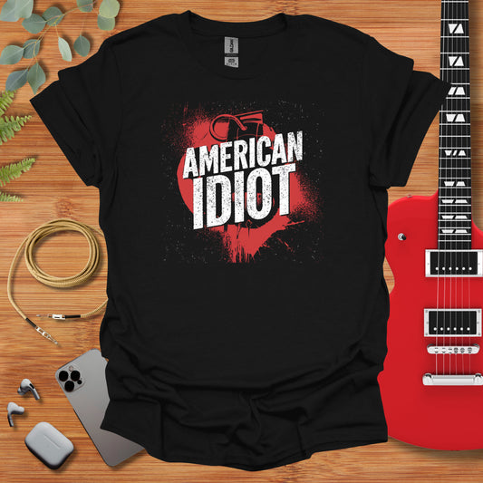 an american idiot t - shirt next to a guitar