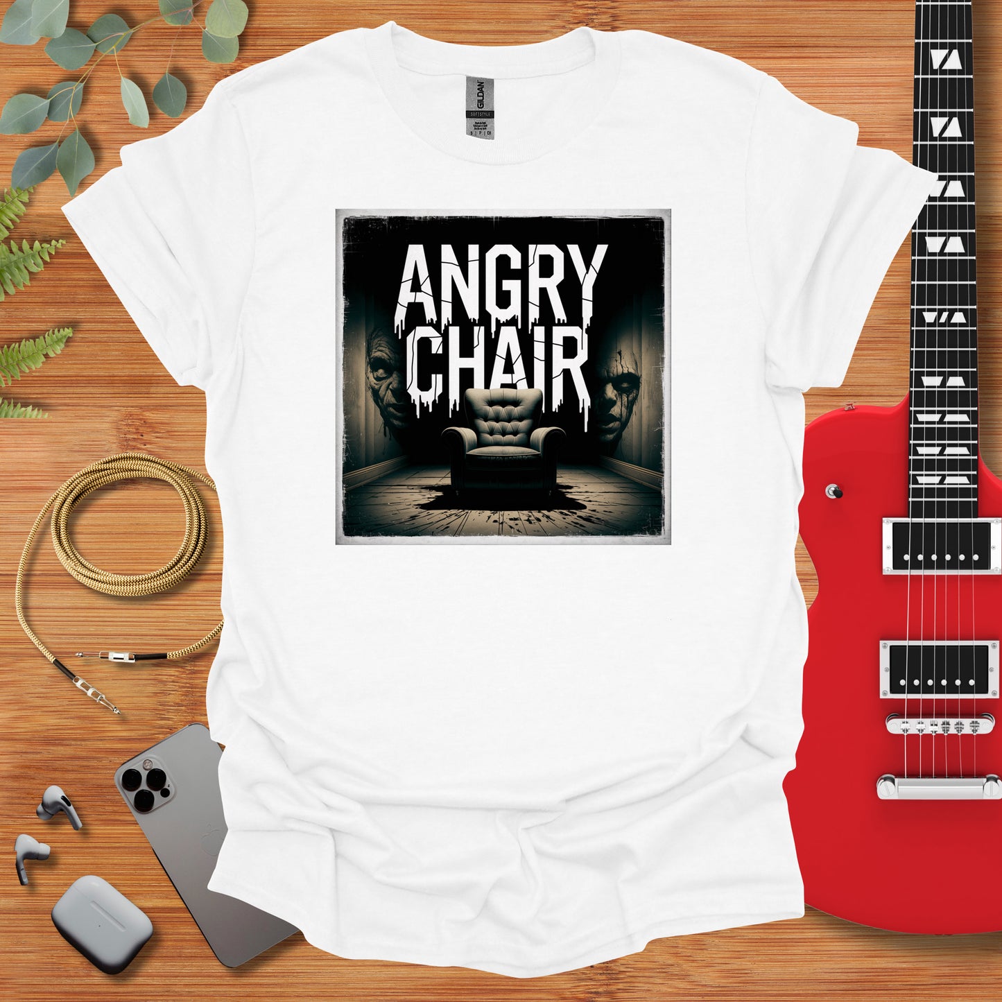 a white t - shirt with an image of a chair and a guitar