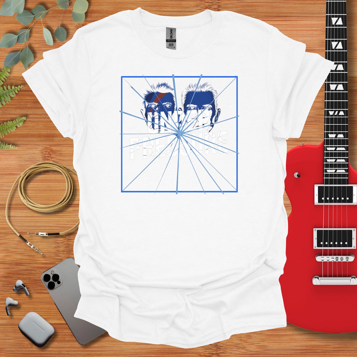 a t - shirt with a picture of two horses on it next to a guitar