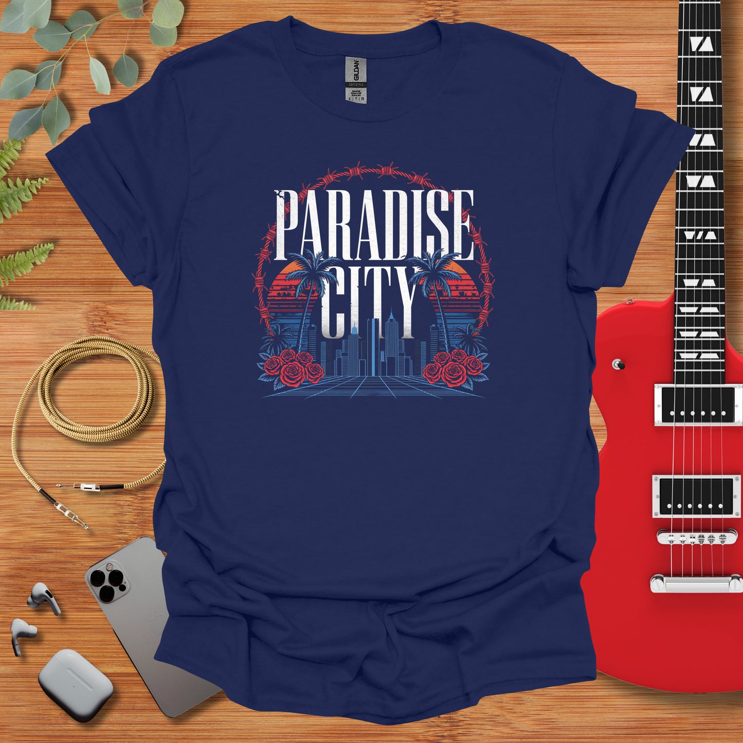 a t - shirt that says paradise city with a guitar next to it