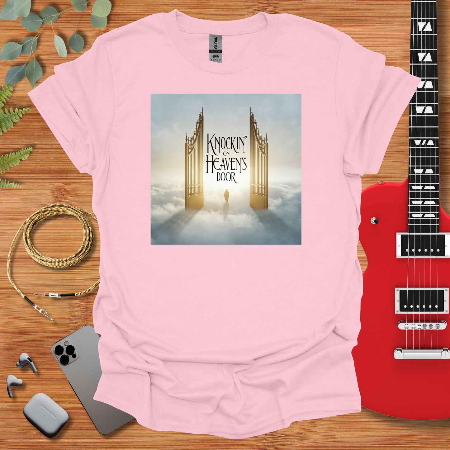 a t - shirt with a picture of a tower and a guitar