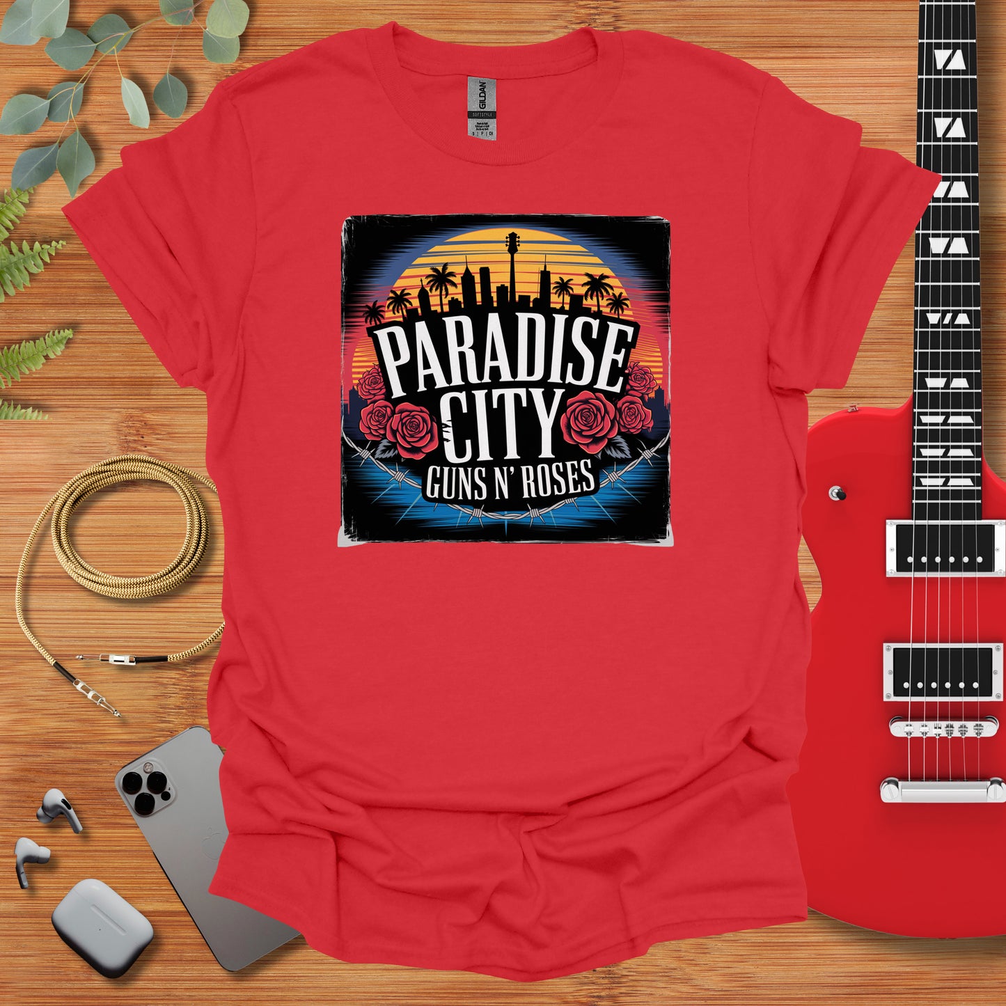 a red shirt that says paradise city guns and roses