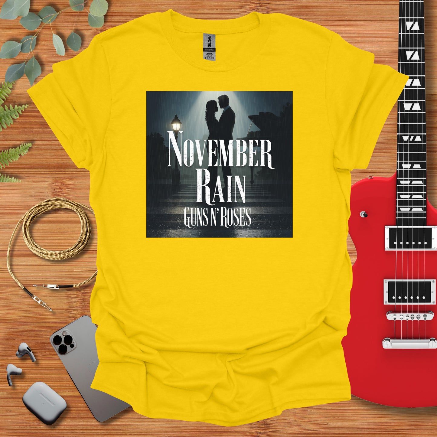 a yellow t - shirt with the words november rain and a guitar next to it