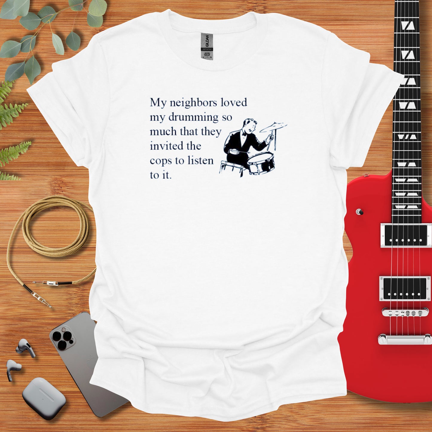 a t - shirt with a picture of a man playing a guitar