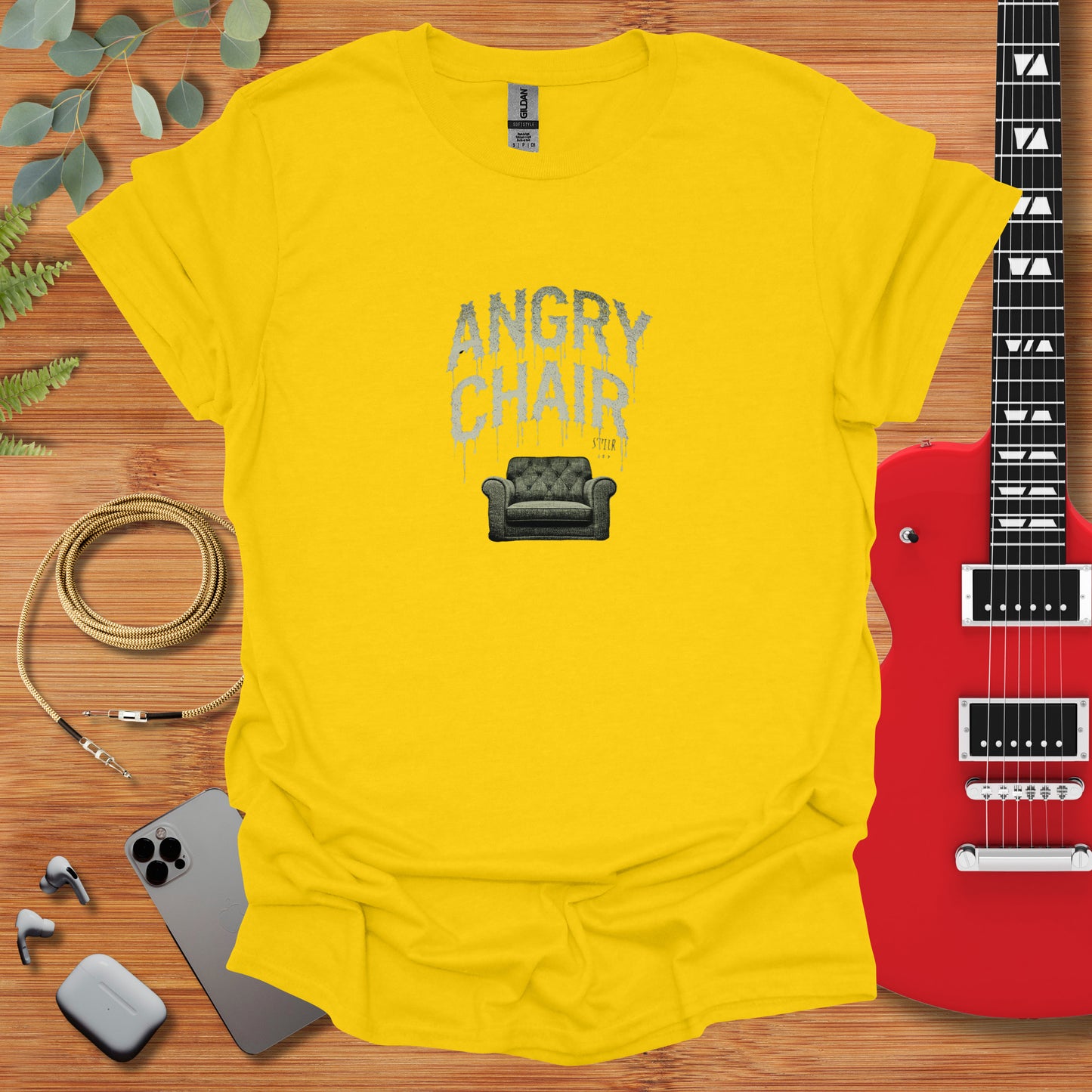 a t - shirt that says angry chair next to a guitar