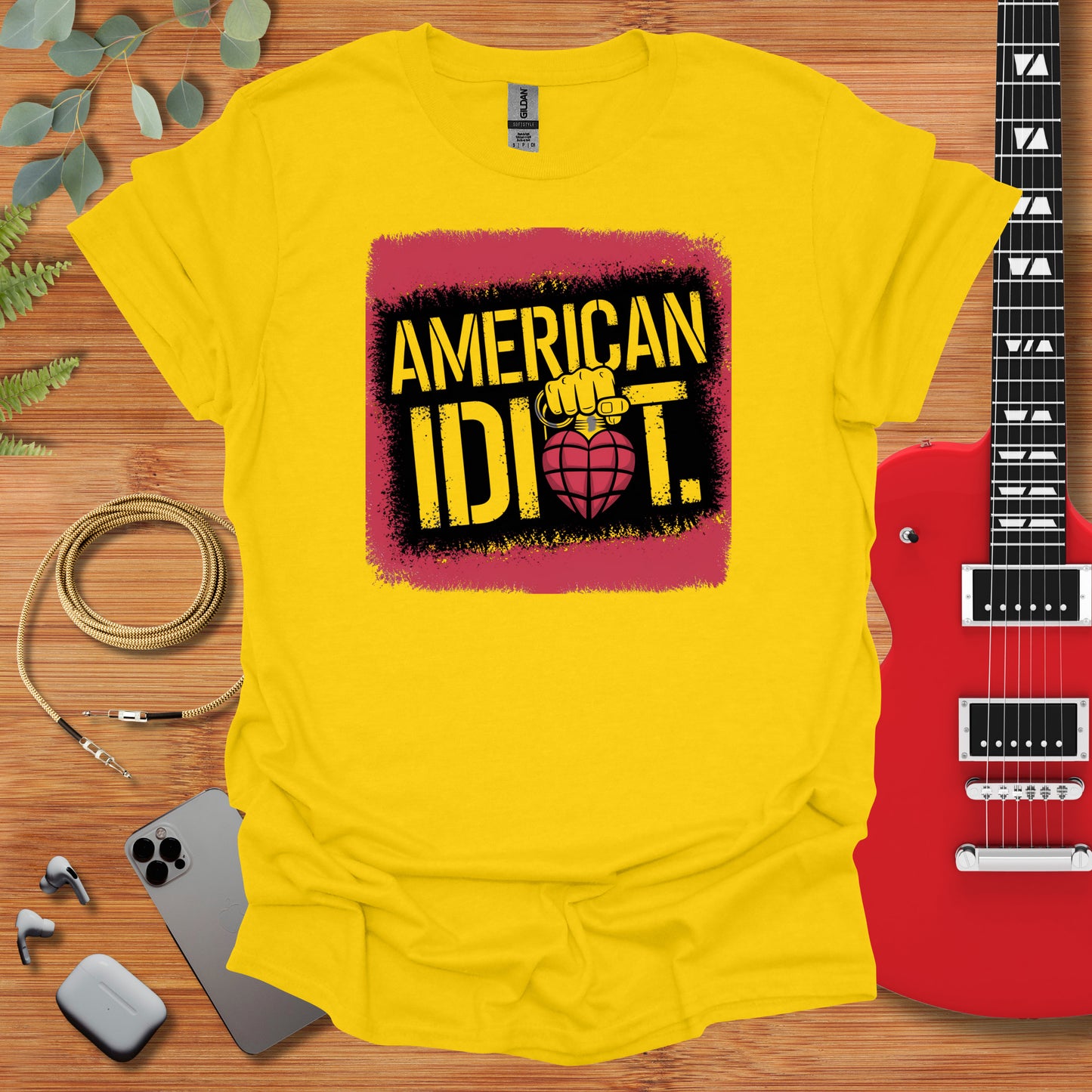 a t - shirt that says american idiot with a guitar next to it