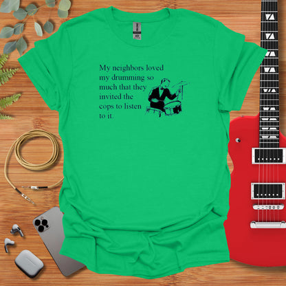 a green t - shirt with a guitar next to it