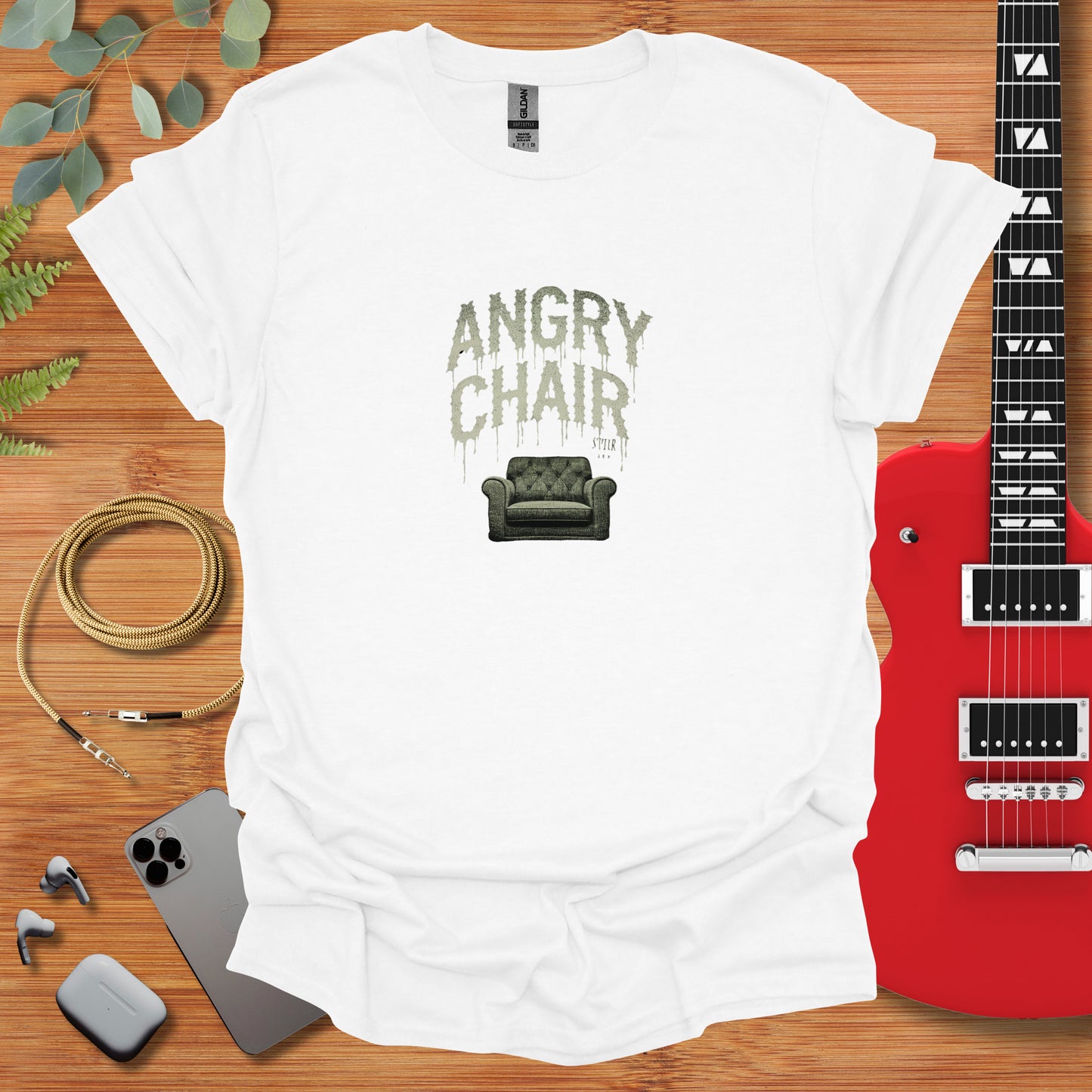 a t - shirt with an image of a couch and guitar