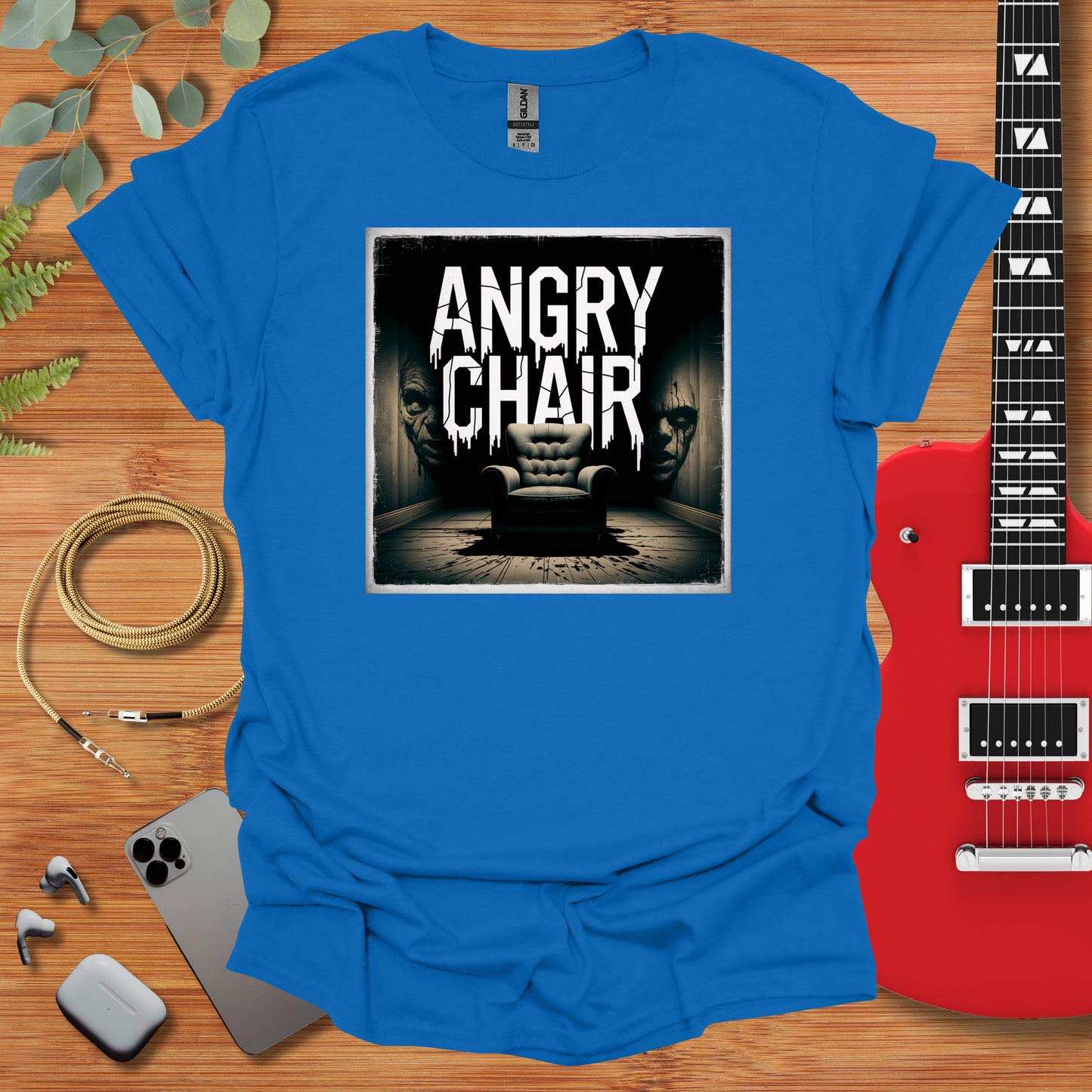 a blue t - shirt with an image of an angry chair on it