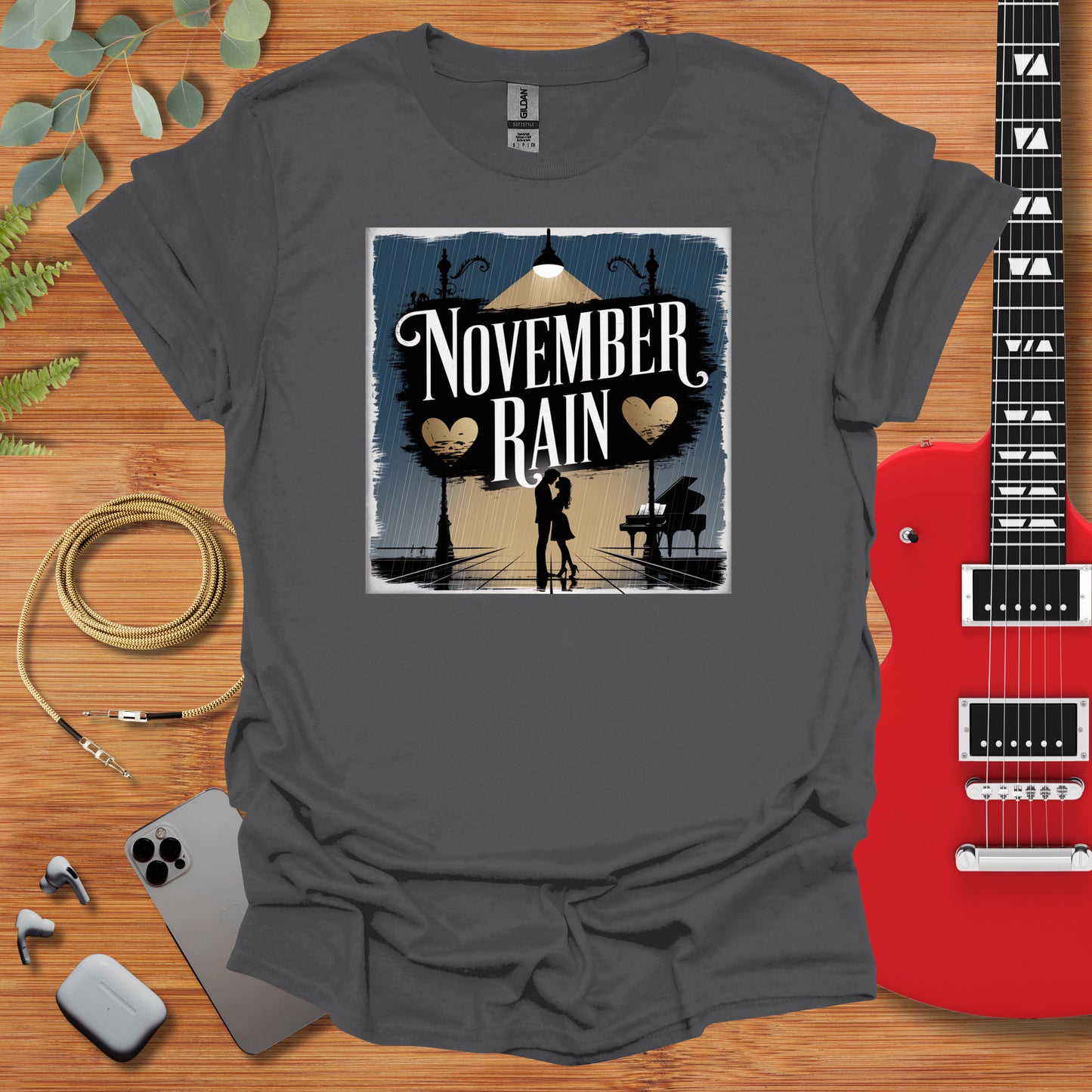 a t - shirt that reads november rain with a silhouette of a person holding a