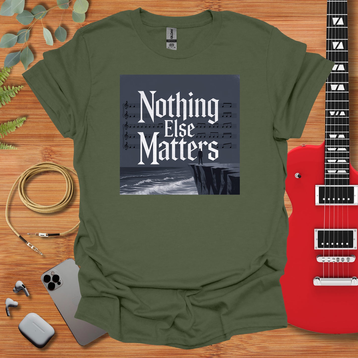 a t - shirt with the words nothing else matters on it next to a guitar